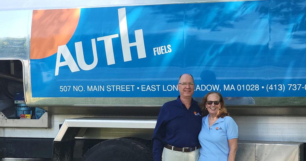 Auth Fuels owners standing in front of fuel truck